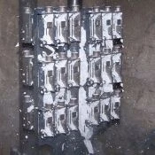 Once trees have cooled, the shell material is removed in vibrating cabinet.
